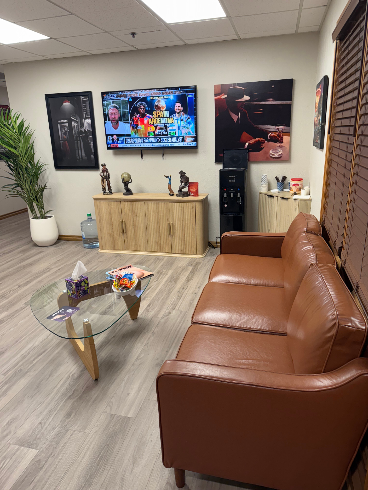 Ultimate Men's Clinic waiting area with leather seating, television, and refreshments.