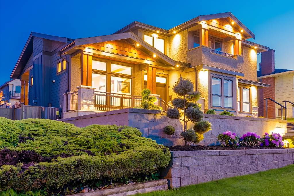 Illuminated modern home with landscaped front yard at dusk showcasing architectural features