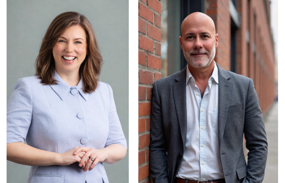 Two professionals, one in a light blue outfit smiling, the other in a gray suit leaning against a brick wall.