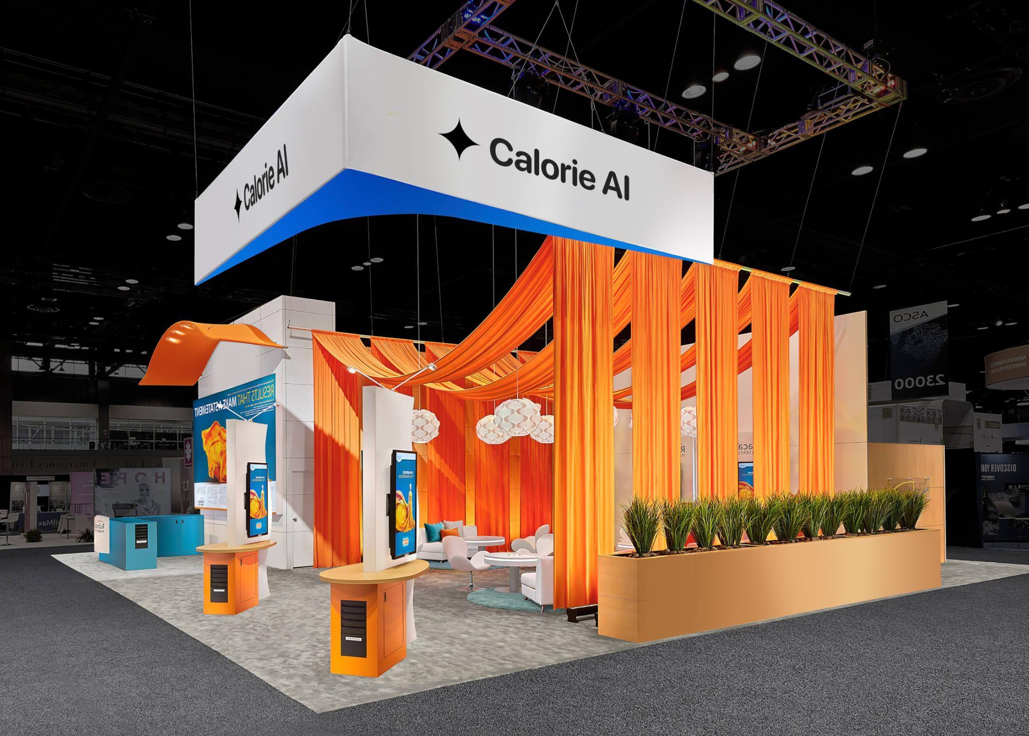 Exhibit booth with orange drapes, modern furniture, and signage for Calorie AI