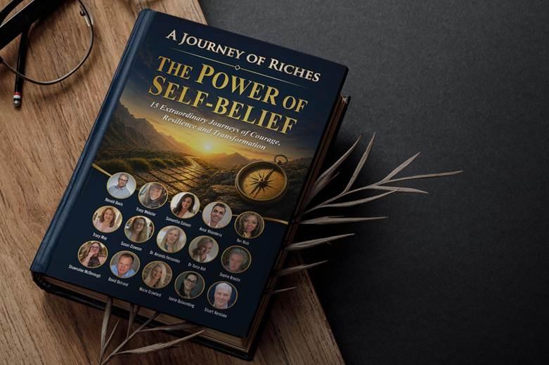 Book titled "The Power of Self-Belief" surrounded by a plant and reading glasses