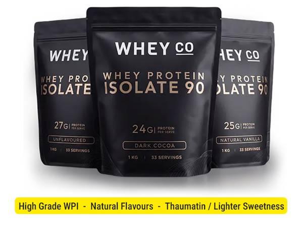 Three black protein powder bags labeled Whey Co with different flavors and nutrition info