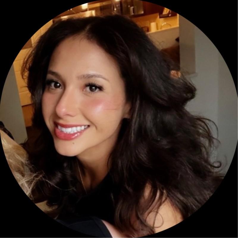 Smiling woman with long, wavy dark hair and a radiant smile in a circular frame
