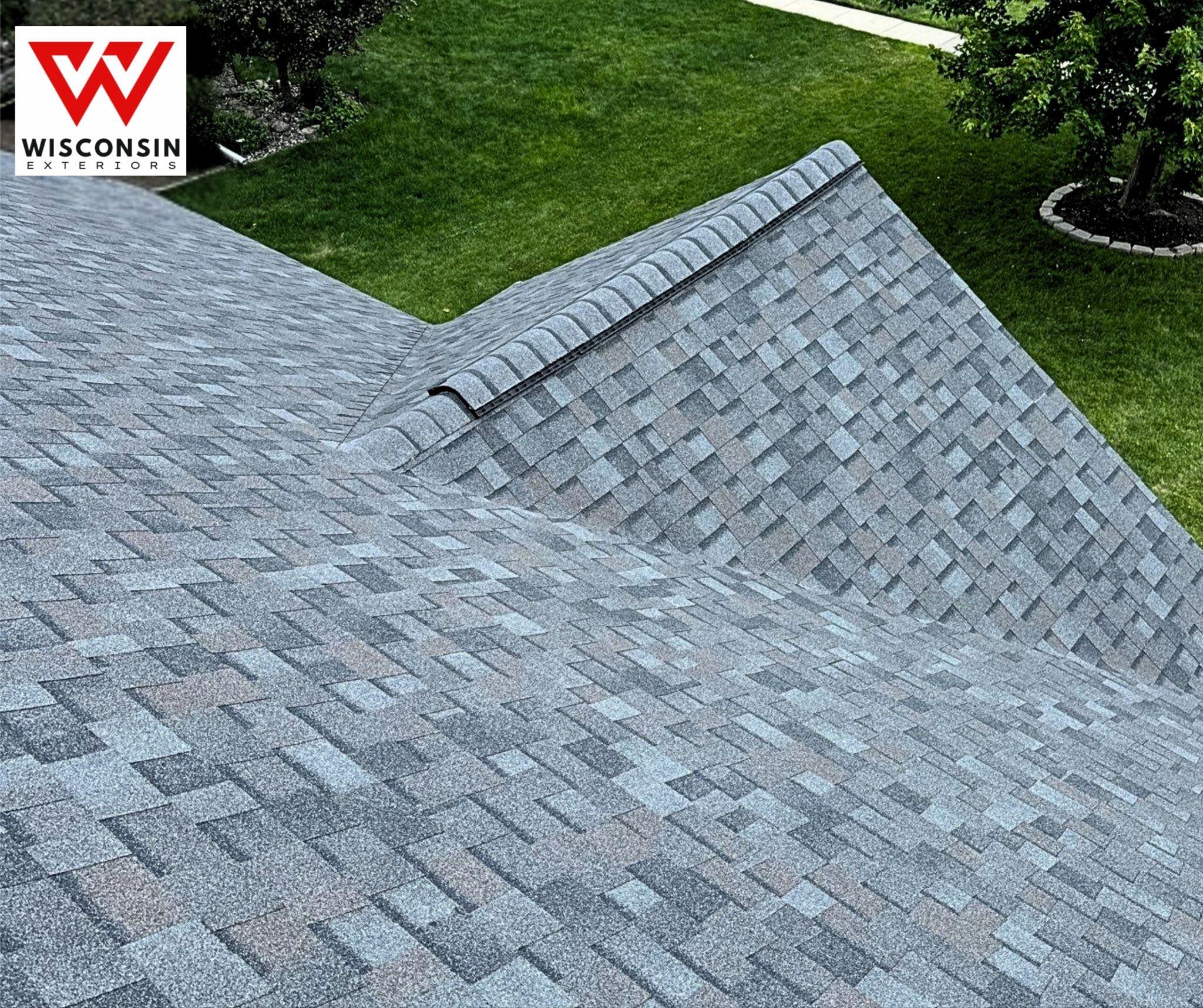 Overhead view of a residential roof with asphalt shingles and a gabled peak
