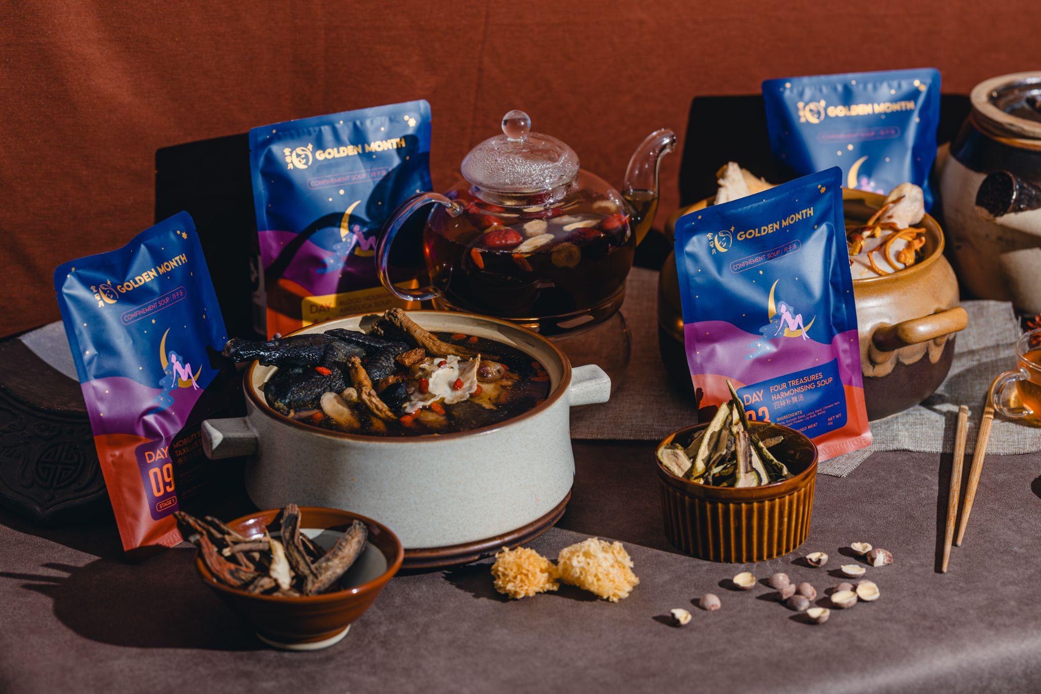 A table set with herbal tea, medicinal ingredients, and colorful packaging.