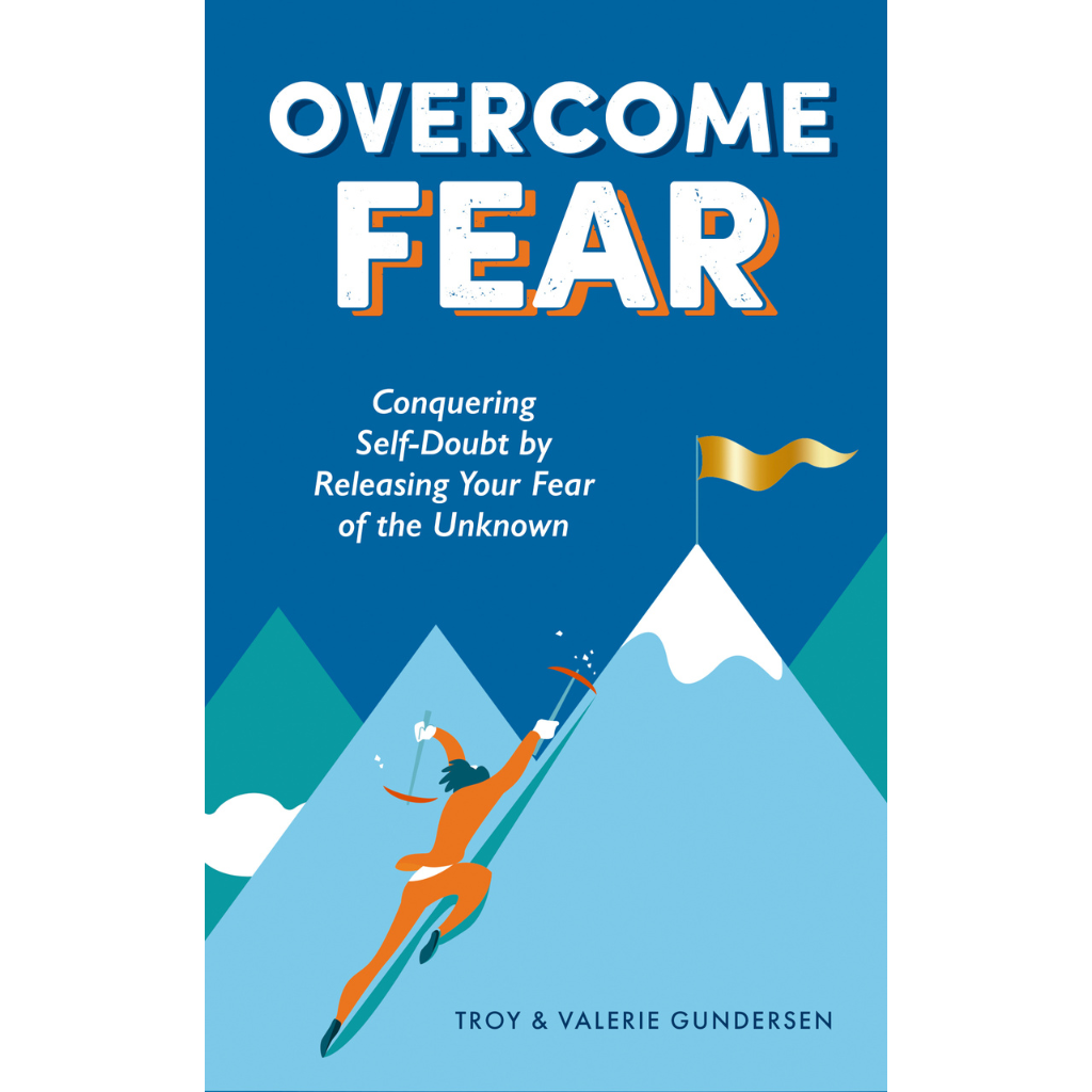 Book cover titled "Overcome Fear" featuring a person skiing down a mountain.