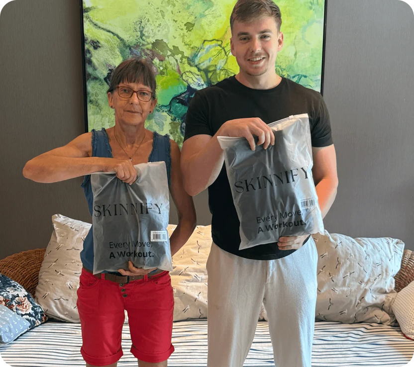 Two people hold fitness bags, standing together in a casual setting with a colorful backdrop