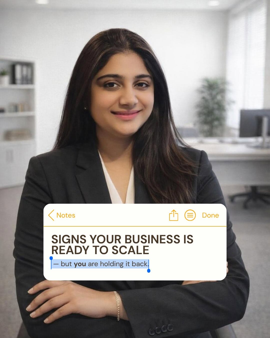 A professional woman in a suit standing confidently in an office setting