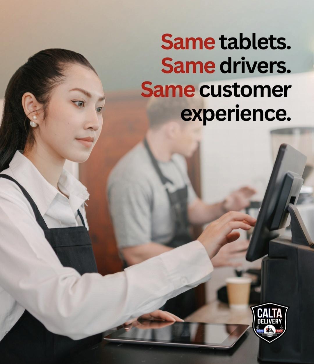 A cashier uses a tablet at a counter while a barista prepares coffee behind.