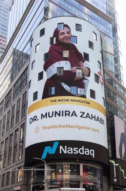 Billboard displaying Dr. Munira Zahabi's image and website in a busy city street