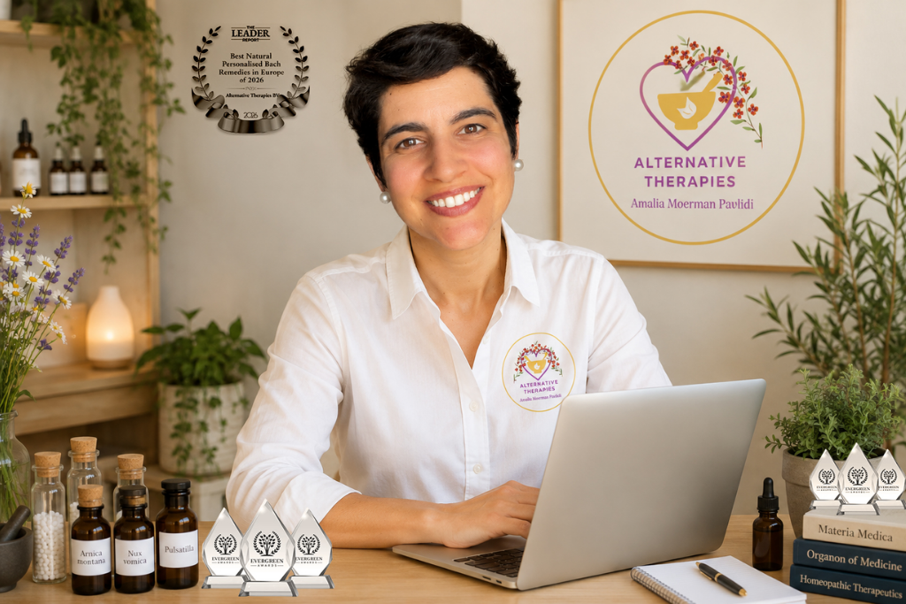 Smiling woman at a desk with essential oils and awards in a wellness setting