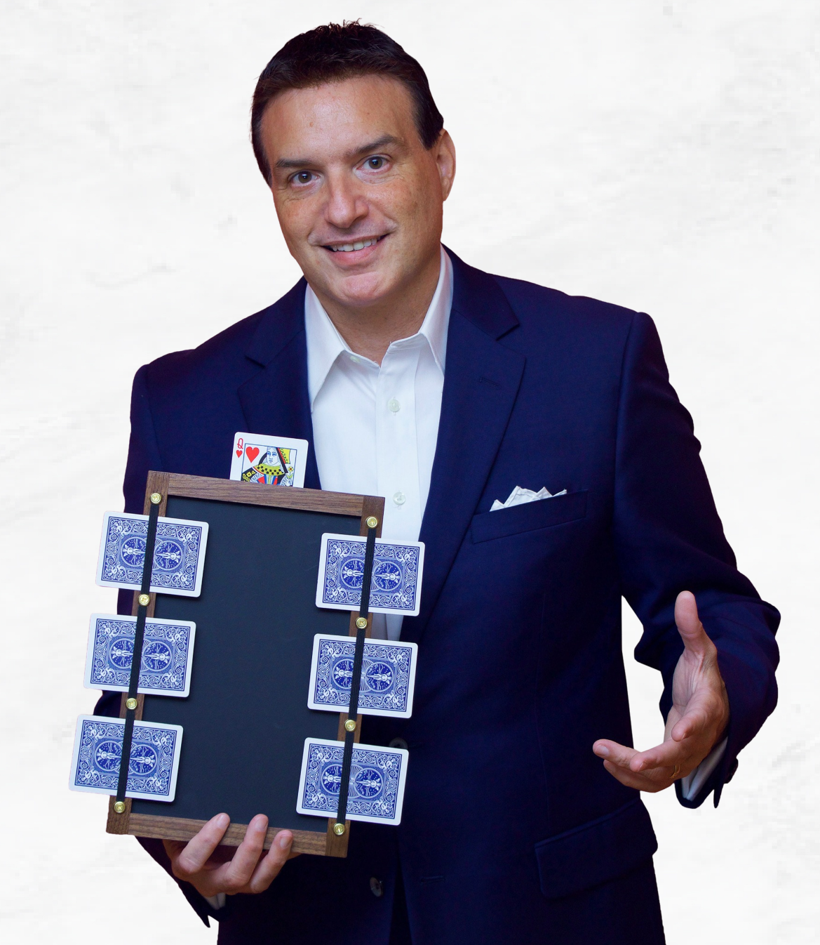 Man in a suit holding a board with playing cards arranged on it