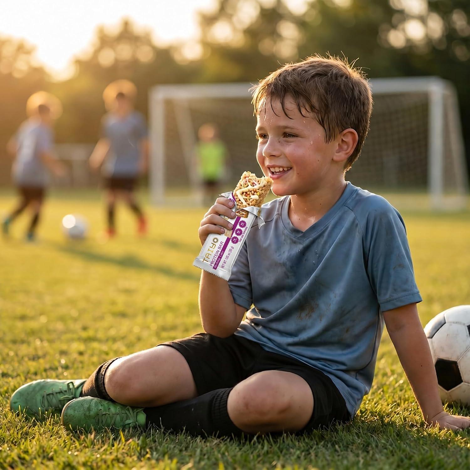 Young boy enjoying a snack on the soccer field after practice, golden hour lighting