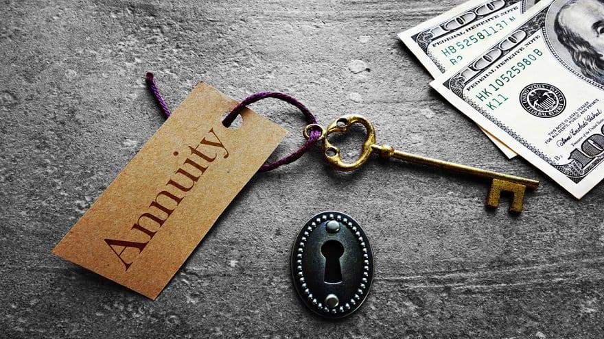 An old key, a lock, and a tag labeled "Annuity" beside cash.