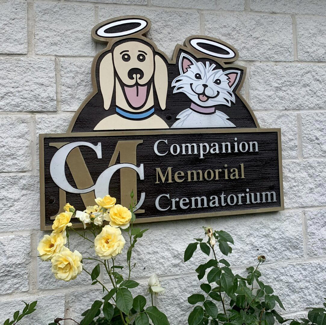 Sign for Companion Memorial Crematorium featuring a dog and cat with halos