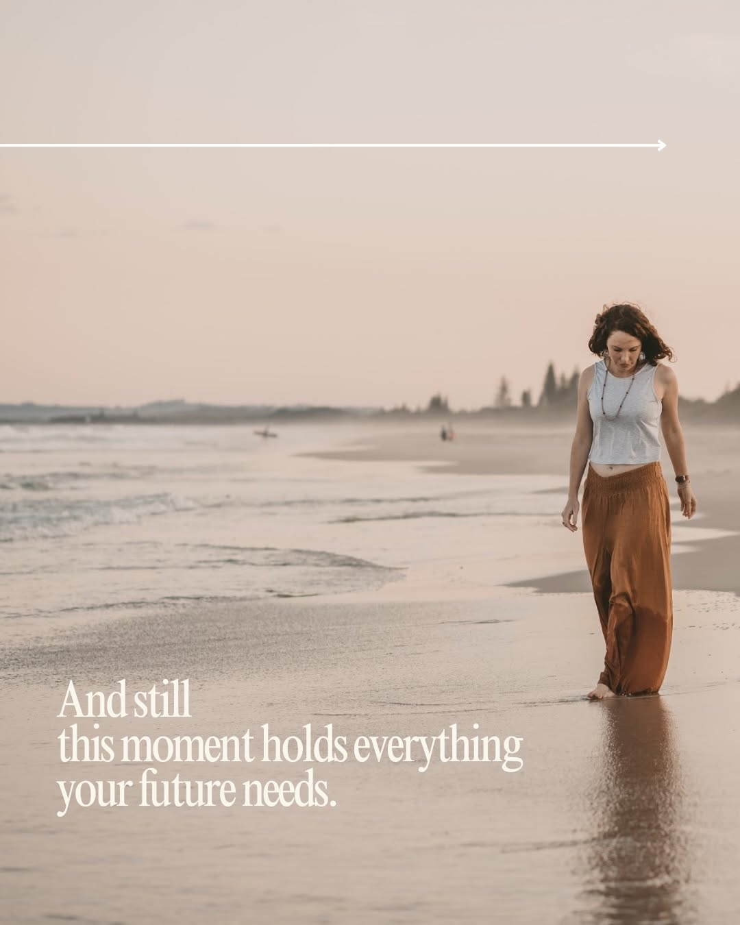 A woman walks along the beach at sunset, reflecting on the moment.