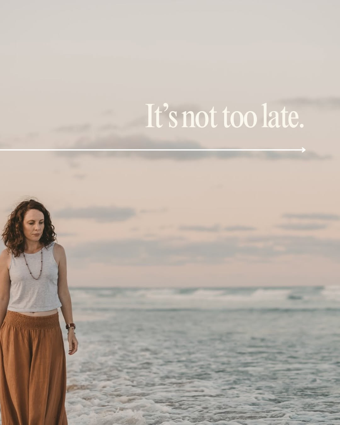 A woman walks along the beach at sunset, reflecting a sense of hope.
