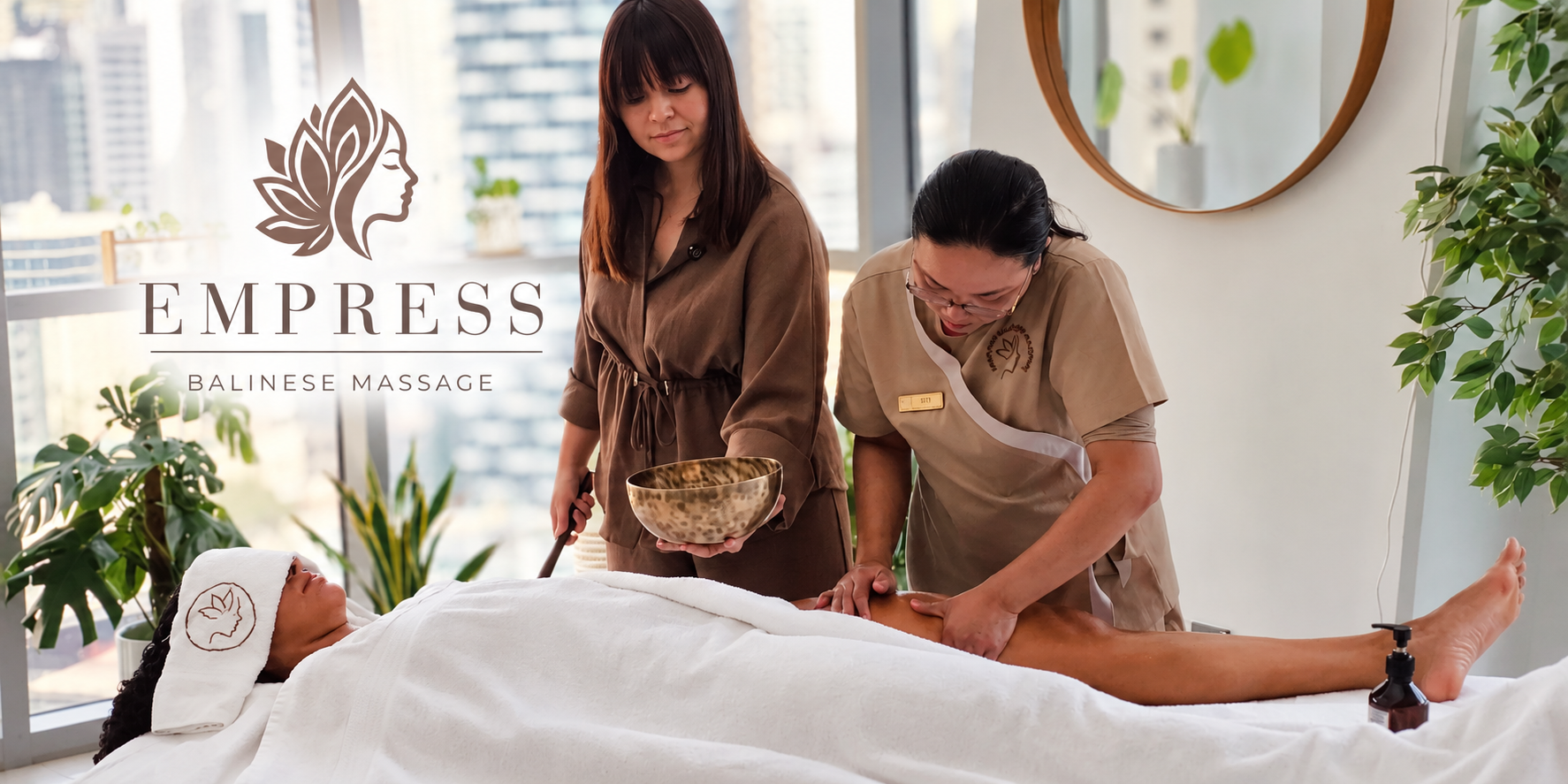 Two therapists performing a Balinese massage in a serene spa setting.