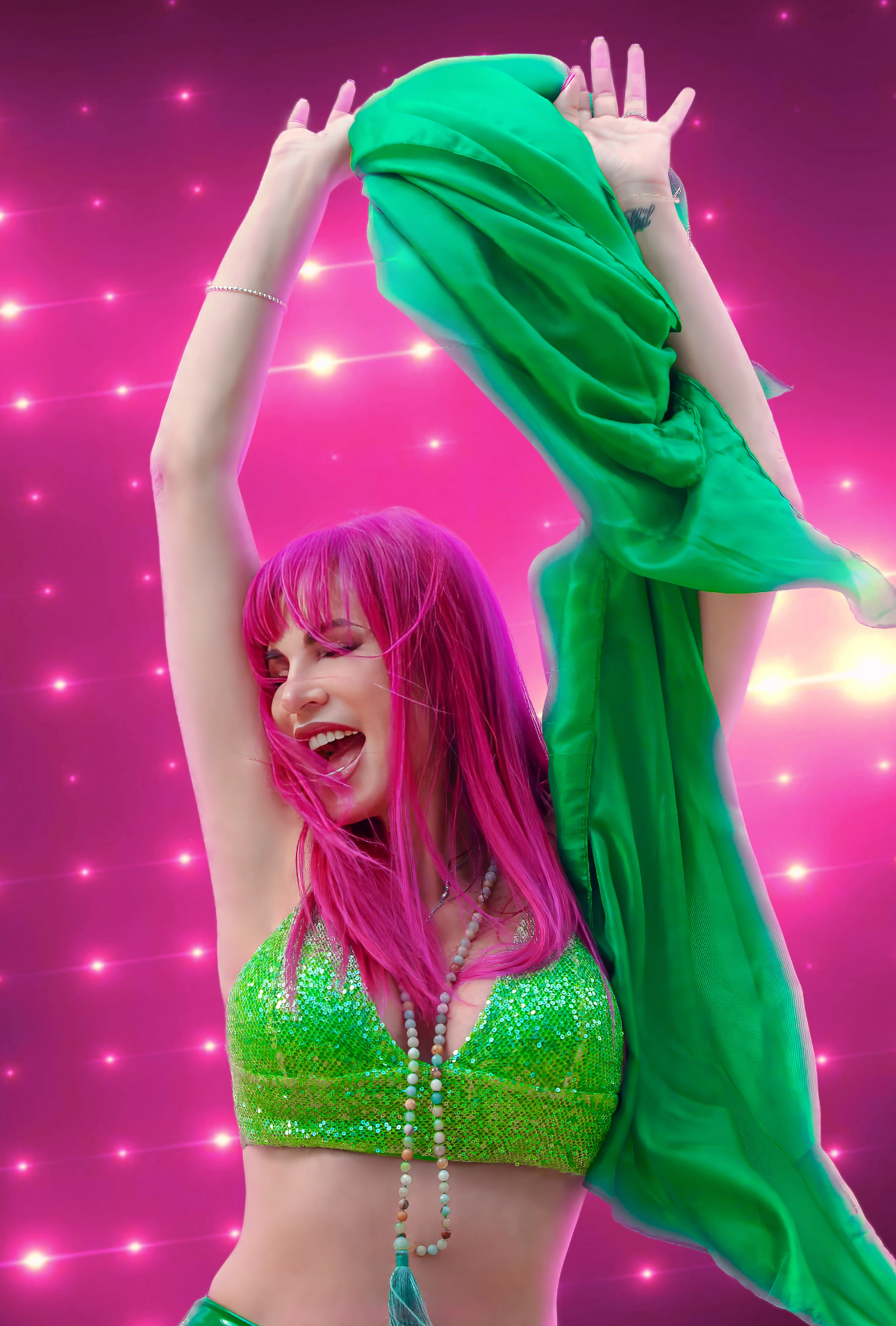 Woman with pink hair joyfully dancing, holding a green scarf against a bright background
