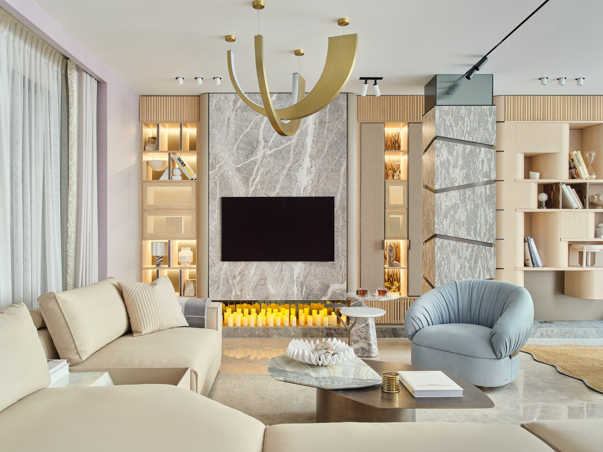 Modern living room featuring elegant furniture, marble accents, and ambient lighting around a TV