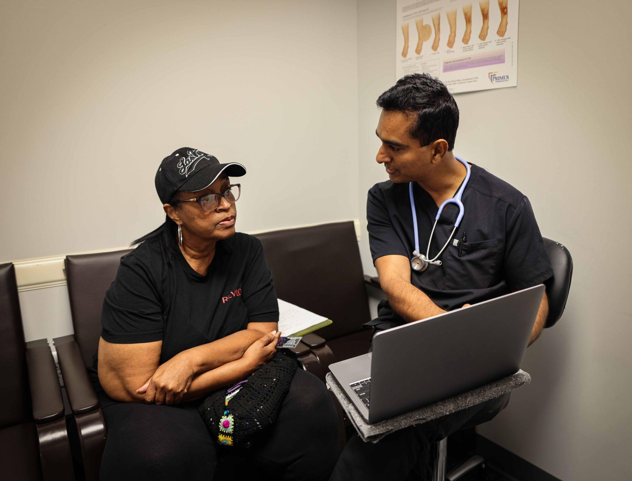 A doctor discusses health with a patient in a medical office setting