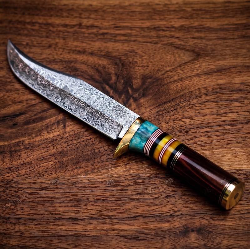 Damascus steel knife with a colorful handle on a wooden surface