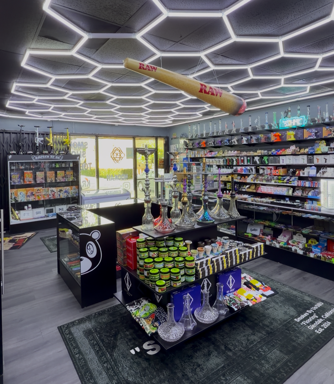 Colorful smoke shop interior displaying various products, including bongs and rolling papers