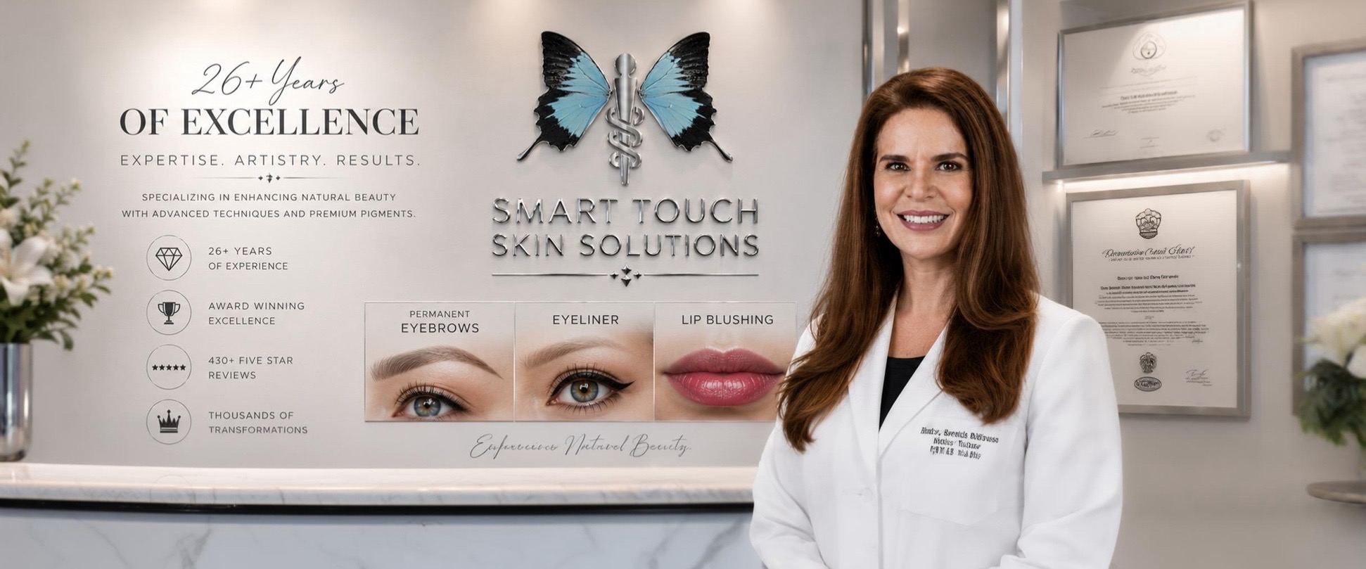 Woman in a lab coat stands in front of a wall displaying beauty service offerings