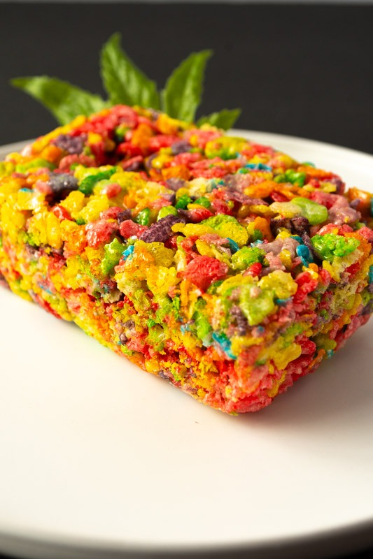 Colorful rice cereal treat shaped like a rectangular bar on a white plate
