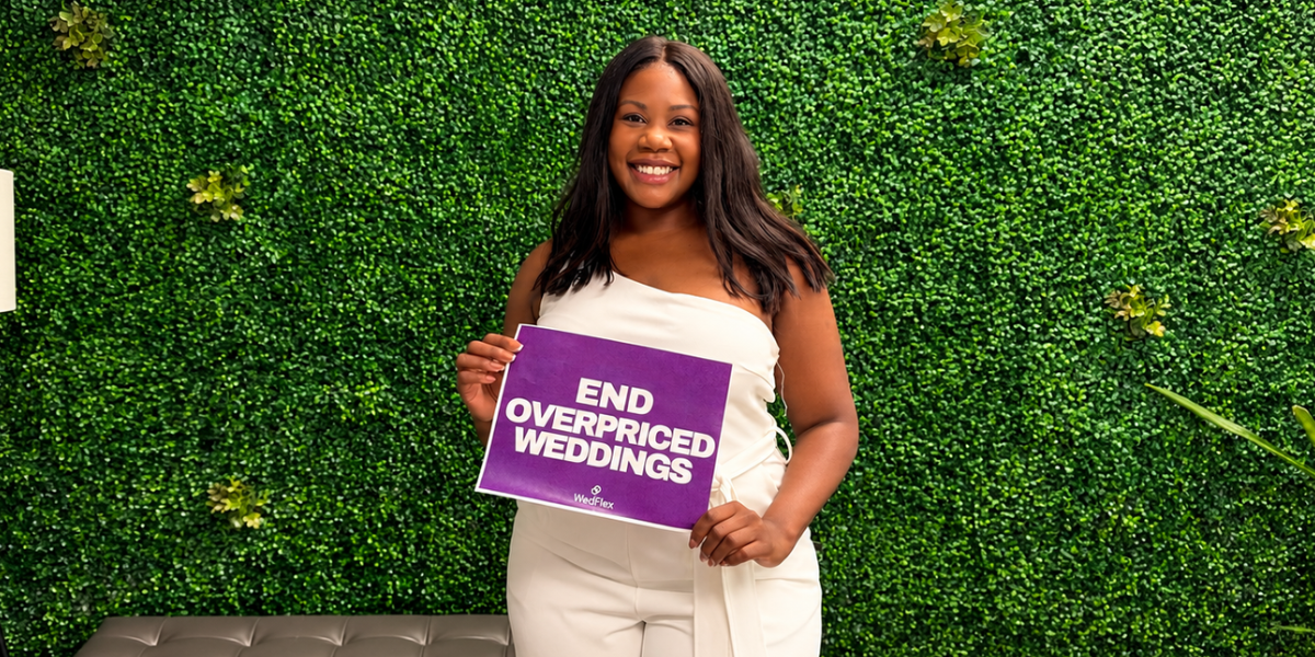 Woman holding a sign that says "End Overpriced Weddings" in front of a green backdrop