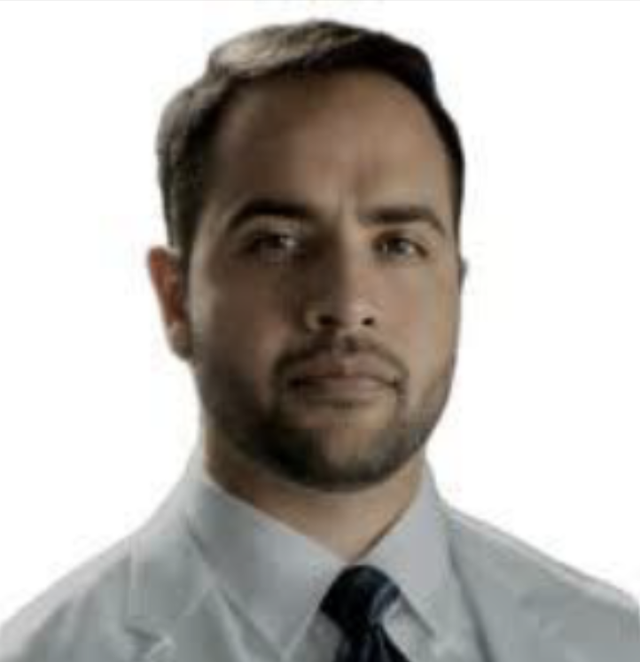 Man with a beard in a white lab coat and tie against a white background