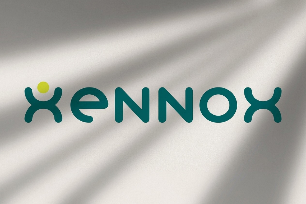 Logo of Xenox featuring a stylized design in teal and a yellow dot