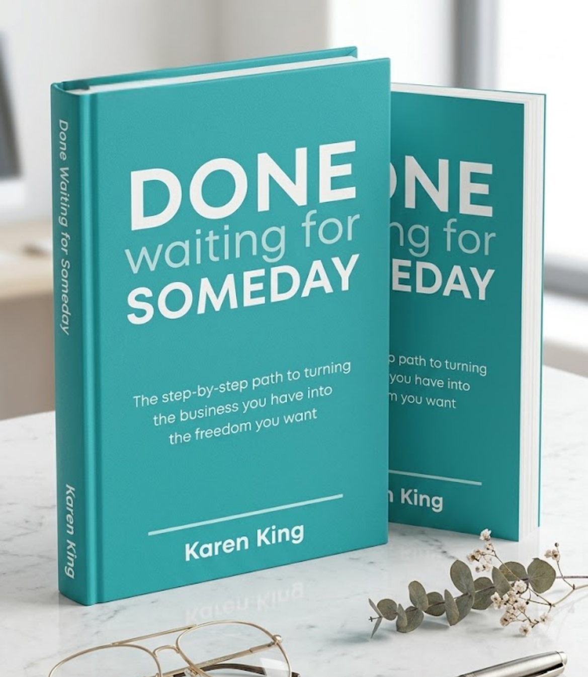 Two teal books titled "DONE waiting for Someday" by Karen King on a table