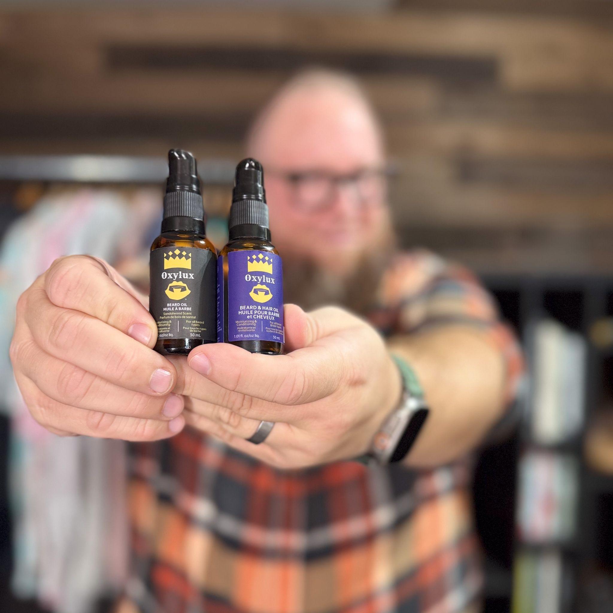 A person holds two bottles of OxyLux skincare products in focus.