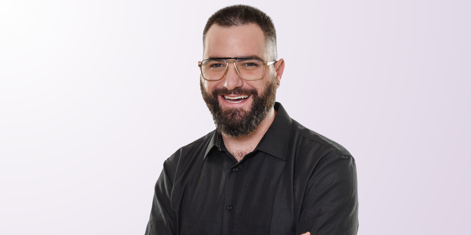 Izac Ross, founder of Haven Headache & Migraine Center, smiling confidently in a professional photo.
