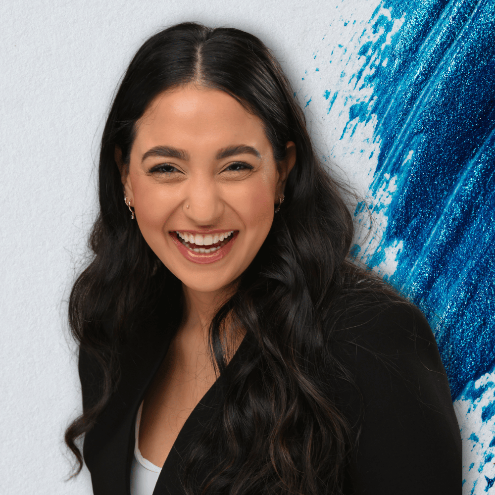 jessica-klair-headshot-laughing-with-blue-splash-background-high-saturation-51435d94.png